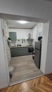 a kitchen with a sink and a refrigerator at Kuća za odmor Sofija in Beli Manastir