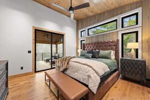 a bedroom with a large bed and windows at sugar mountain lodge in Blue Ridge