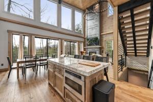 a kitchen and living room with a table and chairs at sugar mountain lodge in Blue Ridge