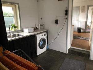 a kitchen with a washing machine and a sink at Rooms in Kruså in Kruså