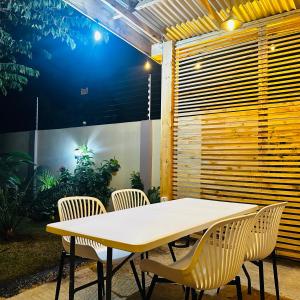a table and chairs in front of a fence at Cherryhomes at Mbezi Juu in Dar es Salaam