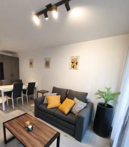 a living room with a couch and a table at Classy Rosario Centro in Rosario