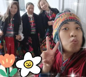 a young boy making a peace sign with a group of girls at Gloria's HOME ISLA Amantaní in Puno