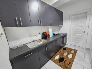 a kitchen with a sink and a counter top at Besa Apartment in Ferizaj