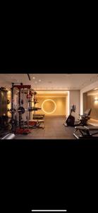 a gym with treadmills and machines in a room at Emmanuel suits in Eilat