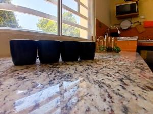 two blue chairs sitting on a counter in a kitchen at Habitación arena, Paseo Durango in Durango +4 photos