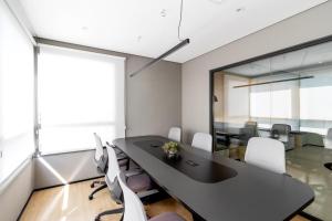 an office with a black table and white chairs at BSR Luxe Studio next to Allianz Park w Rooftop Pool and Pet Friendly in São Paulo +96 photos