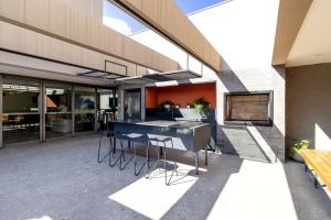 an outdoor patio with a table and chairs at BSR Luxe Studio next to Allianz Park w Rooftop Pool and Pet Friendly in São Paulo