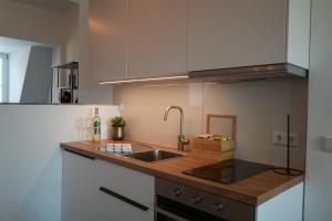 a kitchen with a sink and a wooden counter top at Ferienwohnungen Vito's Apartments Ravensburg in Ravensburg