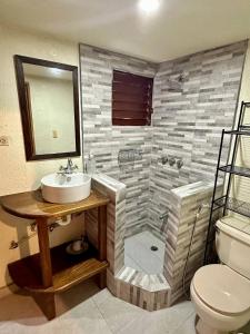 a bathroom with a sink and a shower at 3BR Riverside Secret Retreat in Jarabacoa