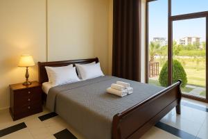 a bedroom with a bed with two towels on it at Apartments Contessa in Ulcinj +60 photos