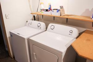 a laundry room with two washing machines and a counter at Walk To Beach And Downtown Lake Geneva! in Lake Geneva