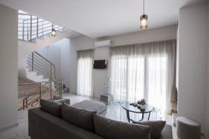 a living room with a couch and a table at Eunoia Luxury Villas in Fanárion