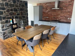a kitchen with a wooden table and chairs at Galgorm Barn in Ballymena