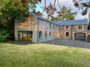an external view of a house with a yard at Galgorm Barn in Ballymena
