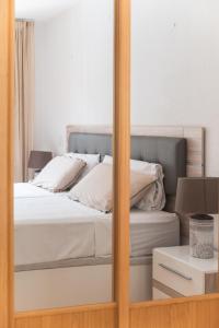 a mirror reflection of a bed in a bedroom at Sunset view, Los Cristianos - Port Royale in Los Cristianos