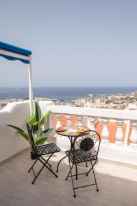 a table and two chairs on a balcony at Sunset view, Los Cristianos - Port Royale in Los Cristianos +45 photos