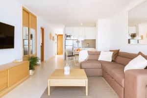 a living room with a couch and a table at Sunset view, Los Cristianos - Port Royale in Los Cristianos