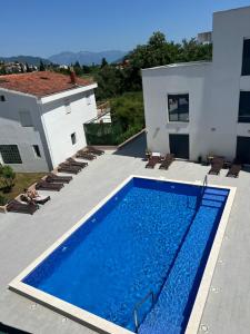 a swimming pool on the roof of a house at Apartment Cica in Igalo +14 photos