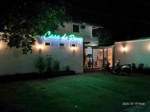 a neon sign on the side of a building at 203 Casa de Rany in Daro