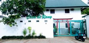 a scooter parked in front of a white building at 203 Casa de Rany in Daro +1 photo