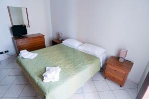 a bedroom with a bed with two night stands and a television at Terrazza di Alfieri - Alloggio con terrazza privata nel centro di Asti in Asti