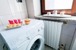 a white washing machine in a kitchen with a pumpkin at Terrazza di Alfieri - Alloggio con terrazza privata nel centro di Asti in Asti