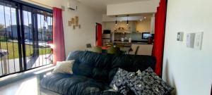 a living room with a couch and a kitchen at Funes Inn in Funes