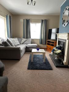 a living room with a couch and a coffee table at A home in Bundoran in Bundoran