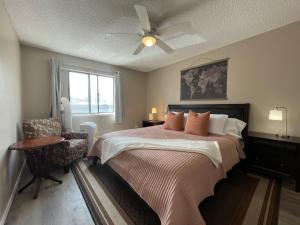 a bedroom with a bed and a ceiling fan at Campus West Nest - King Bed, Walk to CSU in Fort Collins