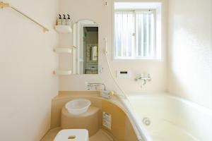 a bathroom with a tub and a toilet and a sink at 1200IN&OUT 10people 75m2 8bed! Exclusive house Shinjuku 13 minutes Shibuya 19 minutesIkebukuro 8 minutes Ueno 9 minutes in Tokyo