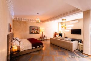 a bedroom with a bed and a couch at Les terrasses du Lac Marrakech in Lalla Takerkoust