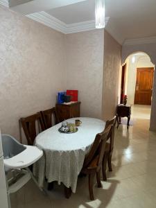 a dining room with a table with wooden chairs at The perfect Riad Al Salam apartment in Agadir