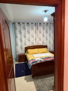 a bedroom with a bed and a window at The perfect Riad Al Salam apartment in Agadir