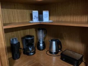 a shelf with coffee makers and a printer on it at Casa Planalto Gramado in Gramado