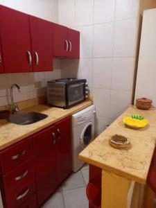 a small kitchen with a sink and a microwave at 80-1 CRISS RESORT-CITY CENTER-NAAMA BAy in Sharm El Sheikh
