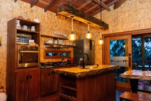 a kitchen with wooden cabinets and a counter top at Cabañas El Edén in Chía