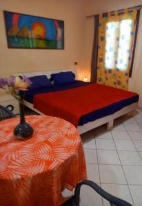 a bedroom with two beds and a vase with flowers at 80-1 CRISS RESORT-CITY CENTER-NAAMA BAy in Sharm El Sheikh