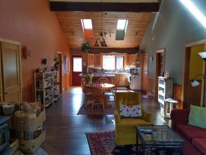 a living room with a table and chairs and a kitchen at Beatrice Place in Slocan