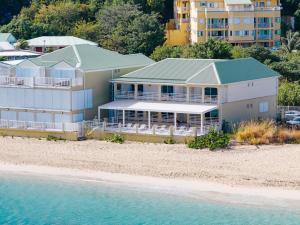 a building on the beach next to the water at Suite 6 Mogador Residence, 2BR, brand-new, rare & luxury, sea view in Grand Case +40 photos