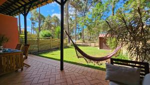 a hammock on a patio with a view of a yard at Apartamento Herdade Aroeira, Praia, Golfe perto Lisboa in Almada