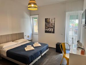 a bedroom with a bed with two towels on it at Sapore di Mare Riviera in Gaeta
