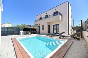 a swimming pool in the backyard of a house at Villa Nino in Sukošan