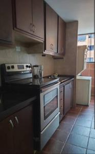 a kitchen with a stove and a stove top oven at Magnífico Apartamento en Mérida in Mérida