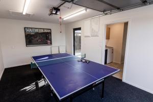 a ping pong table in the middle of a room at Alpine | BBQ & Fireplace | Table Tennis - HS68319 in Hanmer Springs
