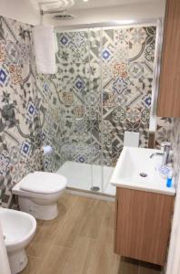 a bathroom with a shower and a toilet and a sink at Sapore di Mare al Duomo in Gaeta