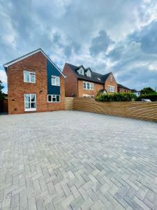 a brick house with a brick driveway in front of it at Spacious Central Oxford Detached Home in Oxford