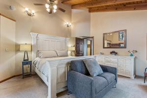 a bedroom with a bed and a chair and a mirror at Burning Tree in Flagstaff