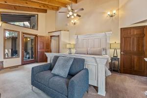 a bedroom with a bed and a blue chair at Burning Tree in Flagstaff