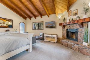 a bedroom with a bed and a stone fireplace at Burning Tree in Flagstaff